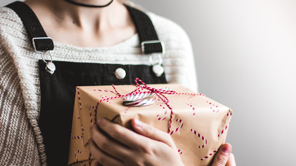 close up photography of woman holding grey and red box